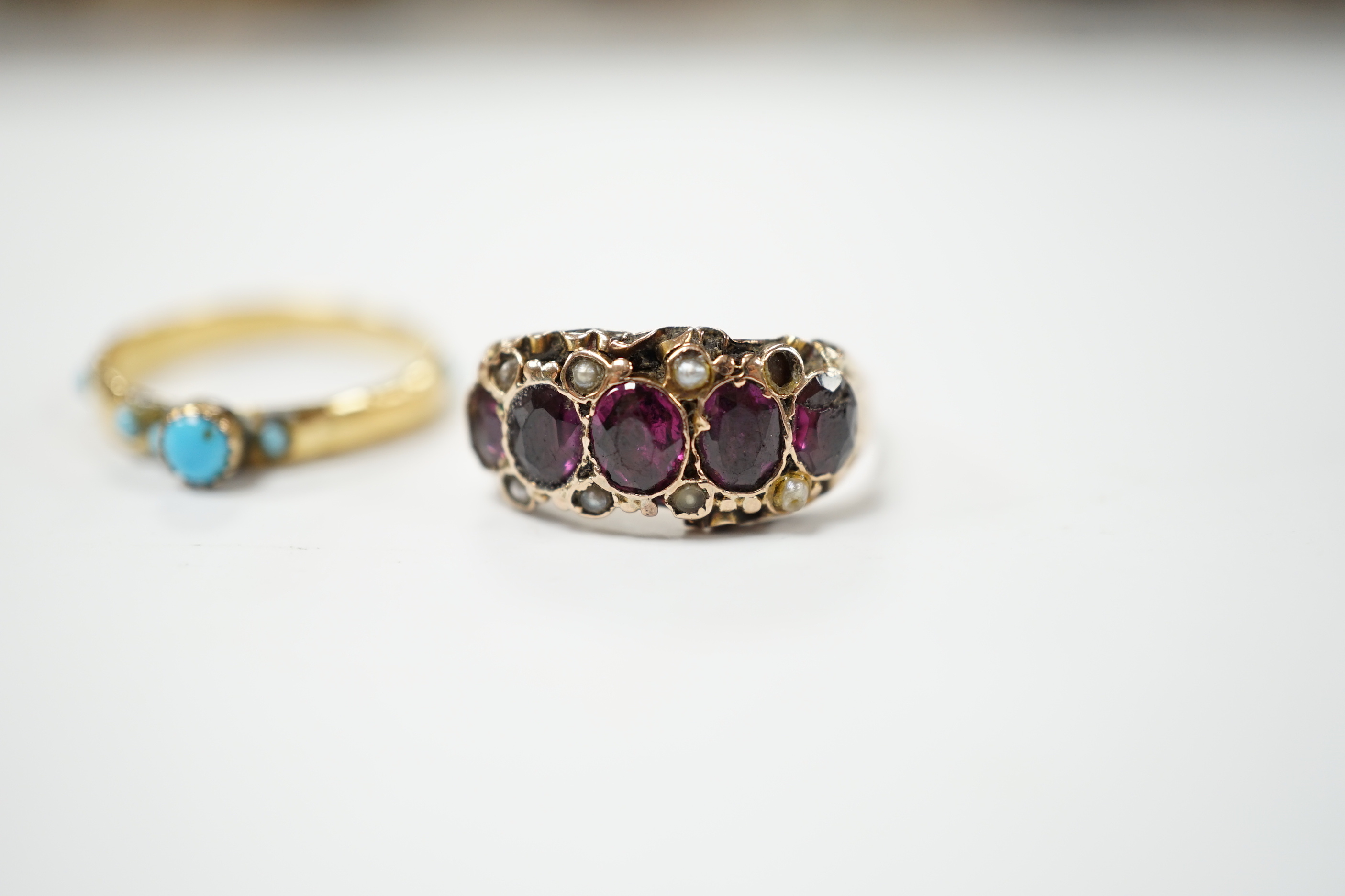A Victorian garnet and seed pearl dress ring, size O, and a turquoise set yellow dress ring, size K